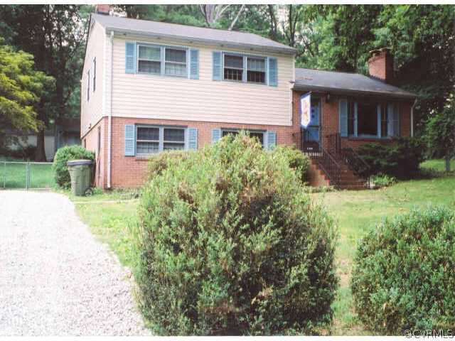 7111 Shawnee Road Richmond, VA 23225 - Photo 1 of 10 a front view of a house with garden
