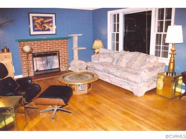 7111 Shawnee Road Richmond, VA 23225 - Photo 3 of 10 a living room with furniture a rug and a fireplace
