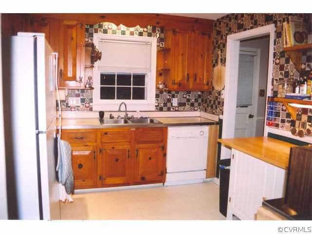 7111 Shawnee Road Richmond, VA 23225 - Photo 4 of 10 a kitchen with stainless steel appliances granite countertop a stove and a refrigerator
