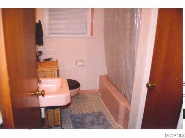 7111 Shawnee Road Richmond, VA 23225 - Photo 8 of 10 a bathroom with a sink and mirror