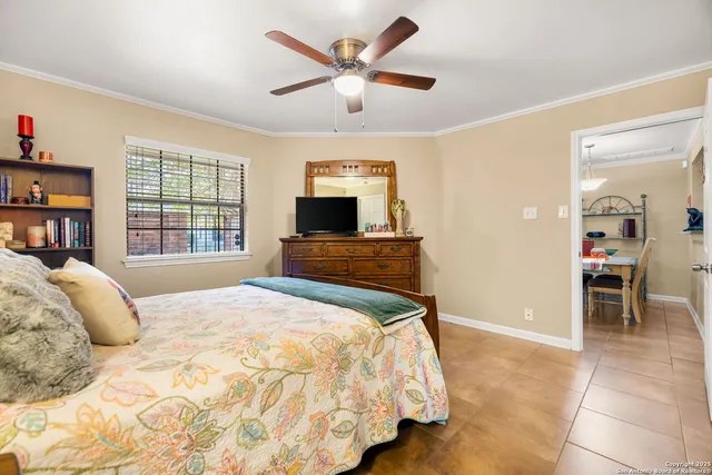 a bedroom with a bed and lamp on desk