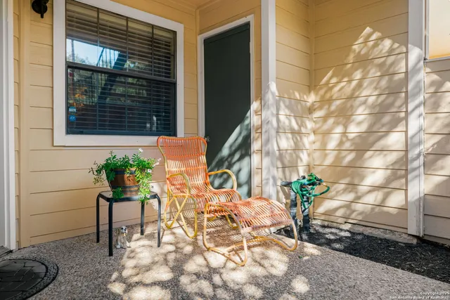 a backyard of a house with table and chairs