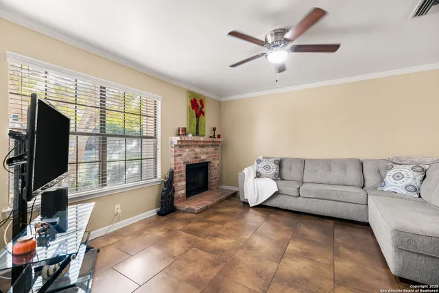 a living room with furniture and a fireplace