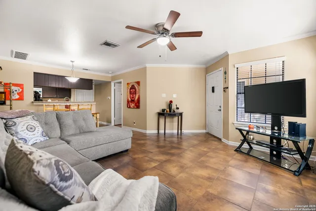 a living room with furniture a fireplace and a flat screen tv
