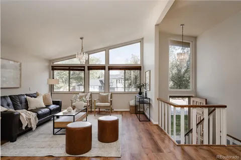 a living room with furniture fireplace and a large window
