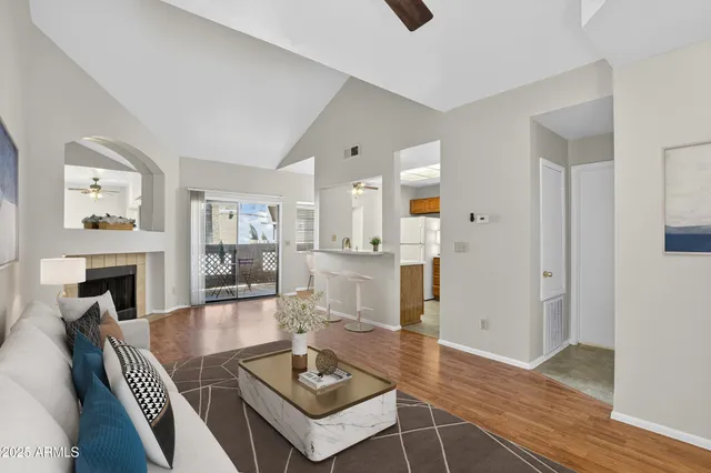 a living room with fireplace furniture and a wooden floor
