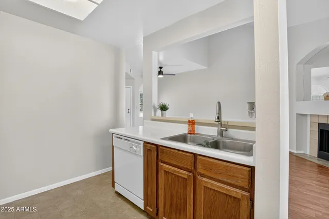 a kitchen with a sink a stove and a window