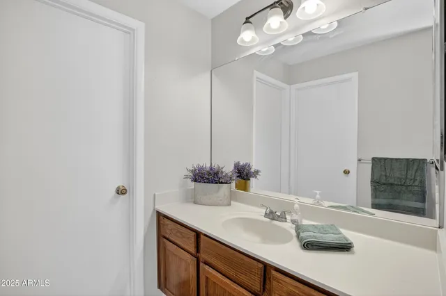 a bathroom with a granite countertop sink a toilet and shower