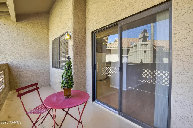 a view of a chairs and table in patio