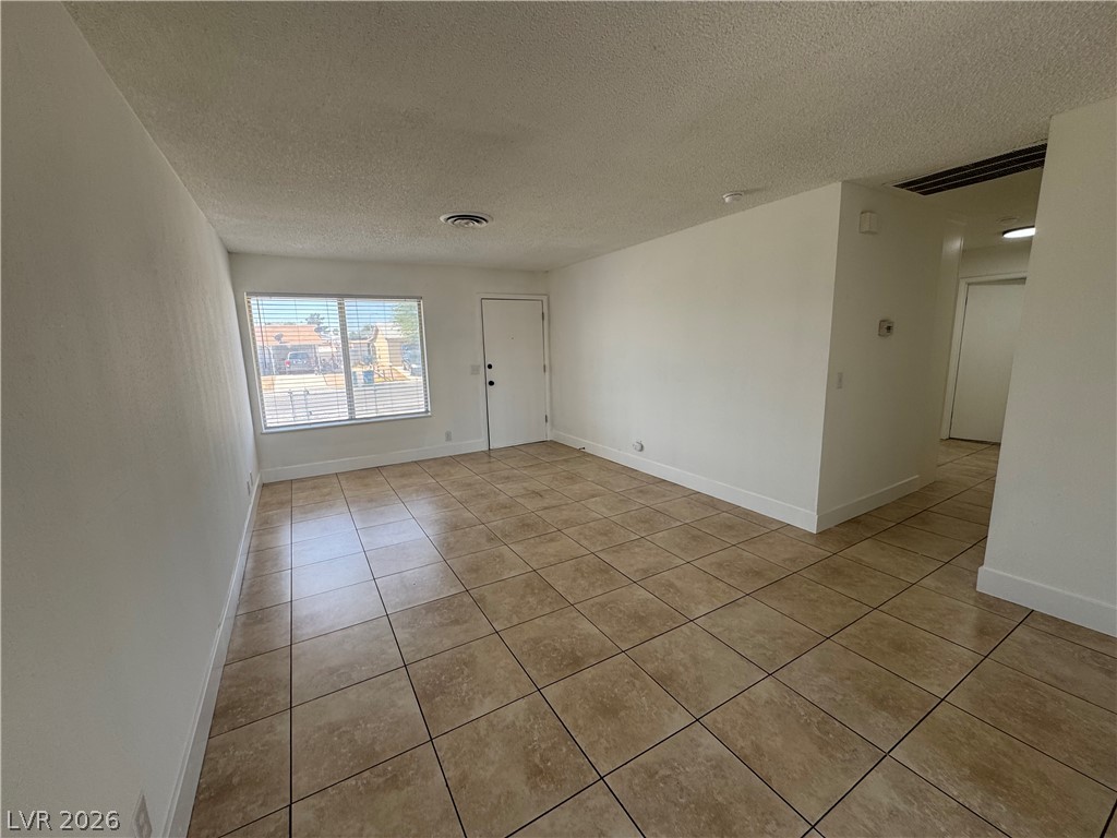 4048 Maple Hill Road Las Vegas, NV 89115 - Photo 21 of 40 Freshly painted Interior. Living room with tiled floors. View towards the front entry.