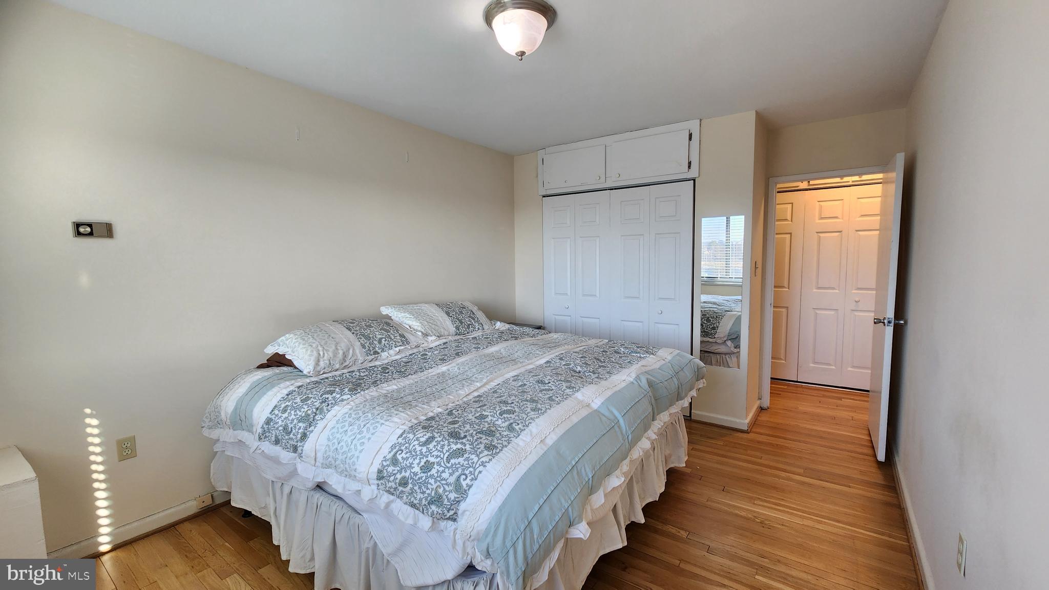 1200 South Arlington Ridge Road, Unit 701 Arlington, VA 22202 - Photo 8 of 12 a bedroom with a bed and a chandelier