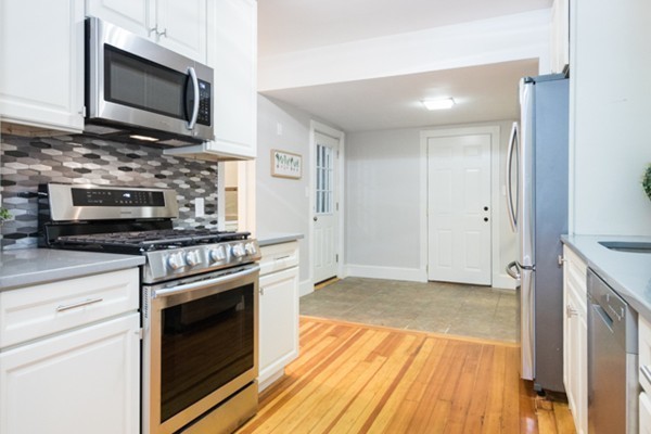 2 Sylvan Road Billerica, MA 01821 - Photo 3 of 12 a kitchen with stainless steel appliances a stove microwave and cabinets