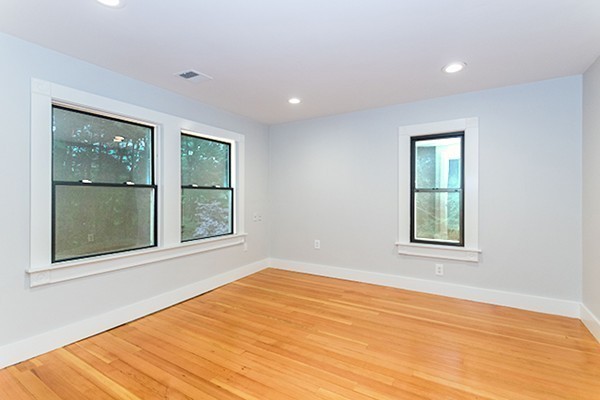 2 Sylvan Road Billerica, MA 01821 - Photo 8 of 12 a view of an empty room with wooden floor and a window