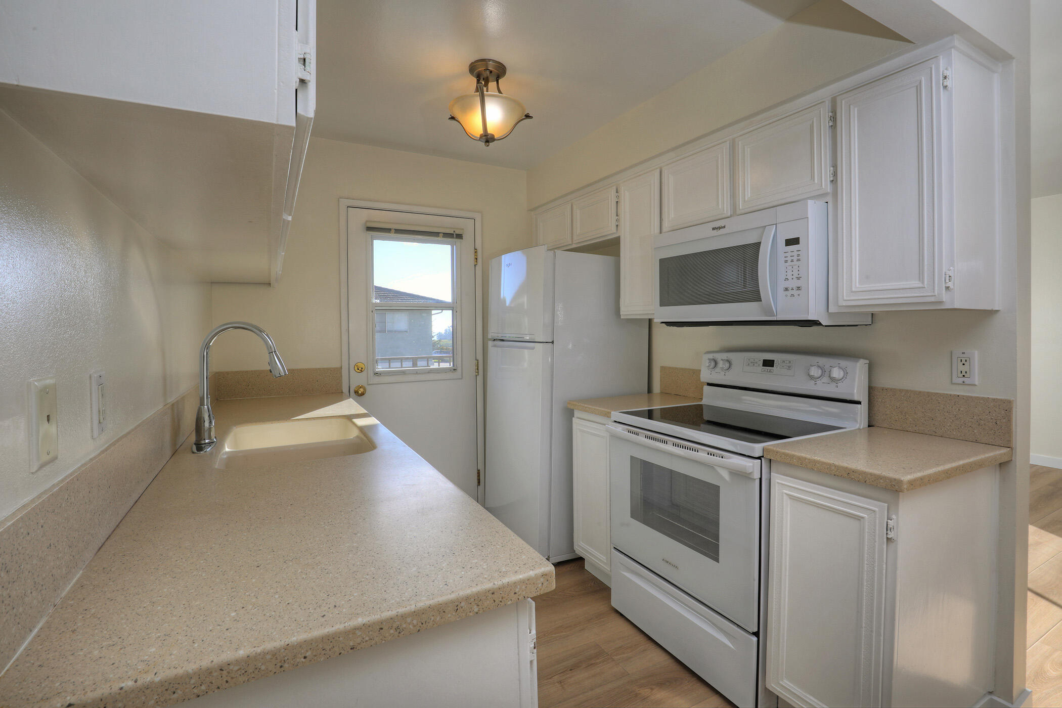 5945 Hickory Street, Unit 4 Carpinteria, CA 93013 - Photo 5 of 19 a kitchen with stainless steel appliances a stove a sink and a microwave