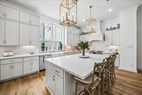 a kitchen with cabinets table and chairs