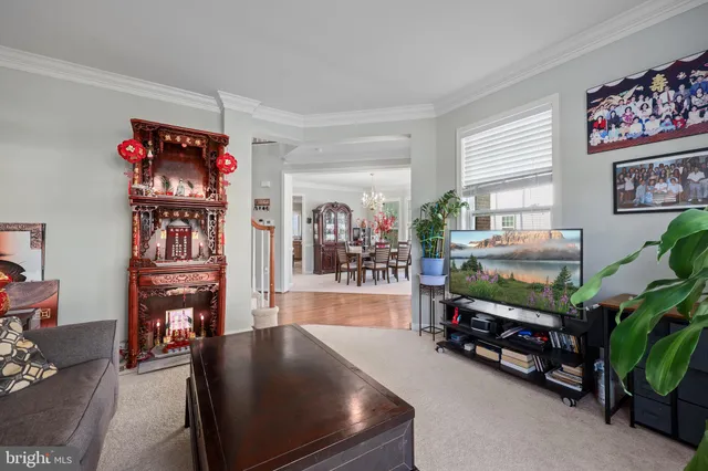 a living room with fireplace furniture and wooden floor