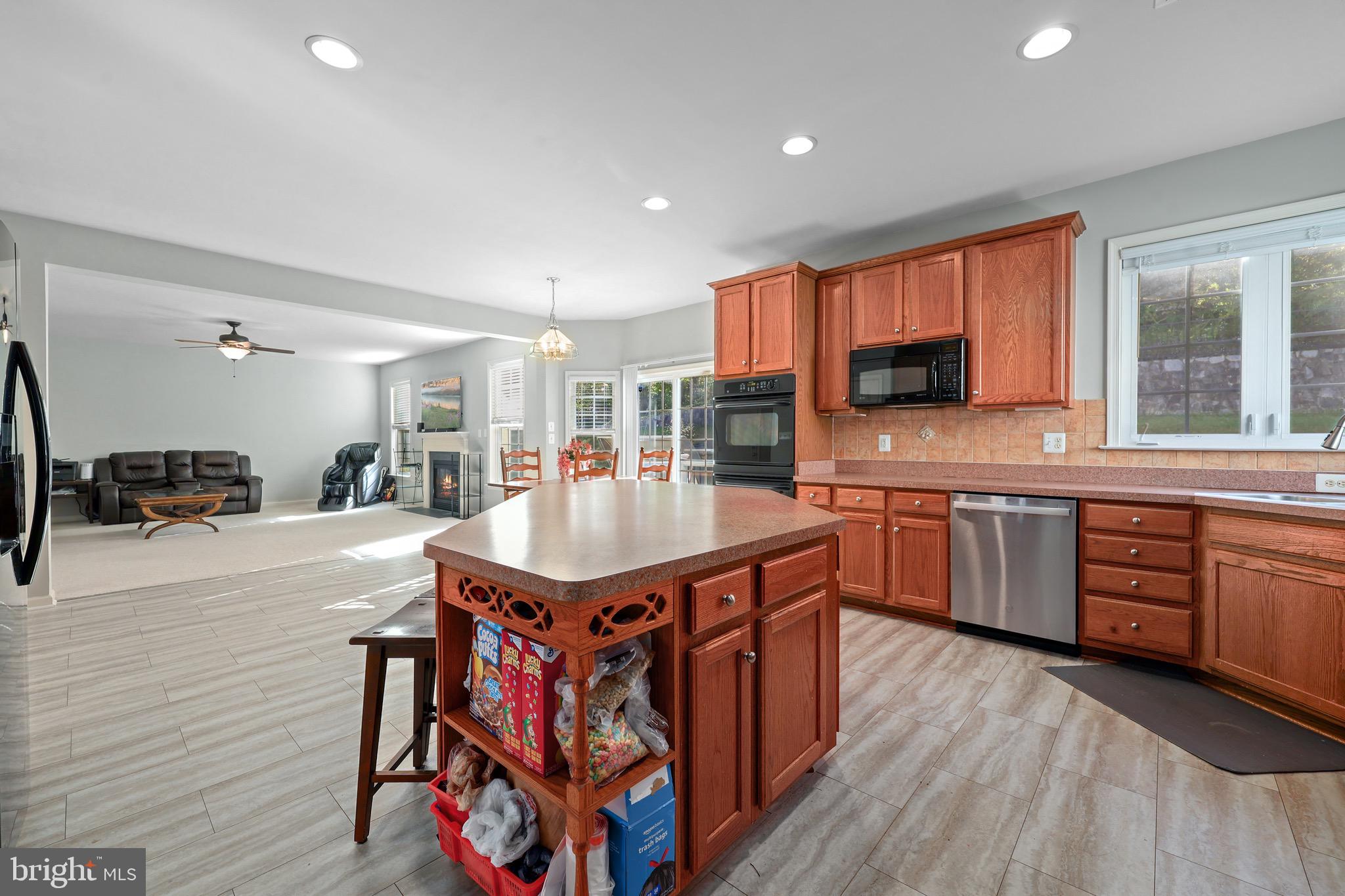 3671 Expedition Drive Triangle, VA 22172 - Photo 22 of 55 a kitchen with stainless steel appliances granite countertop a sink a stove top oven a counter space and cabinets