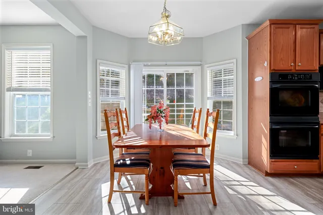 a living room with furniture a flat screen tv and a window