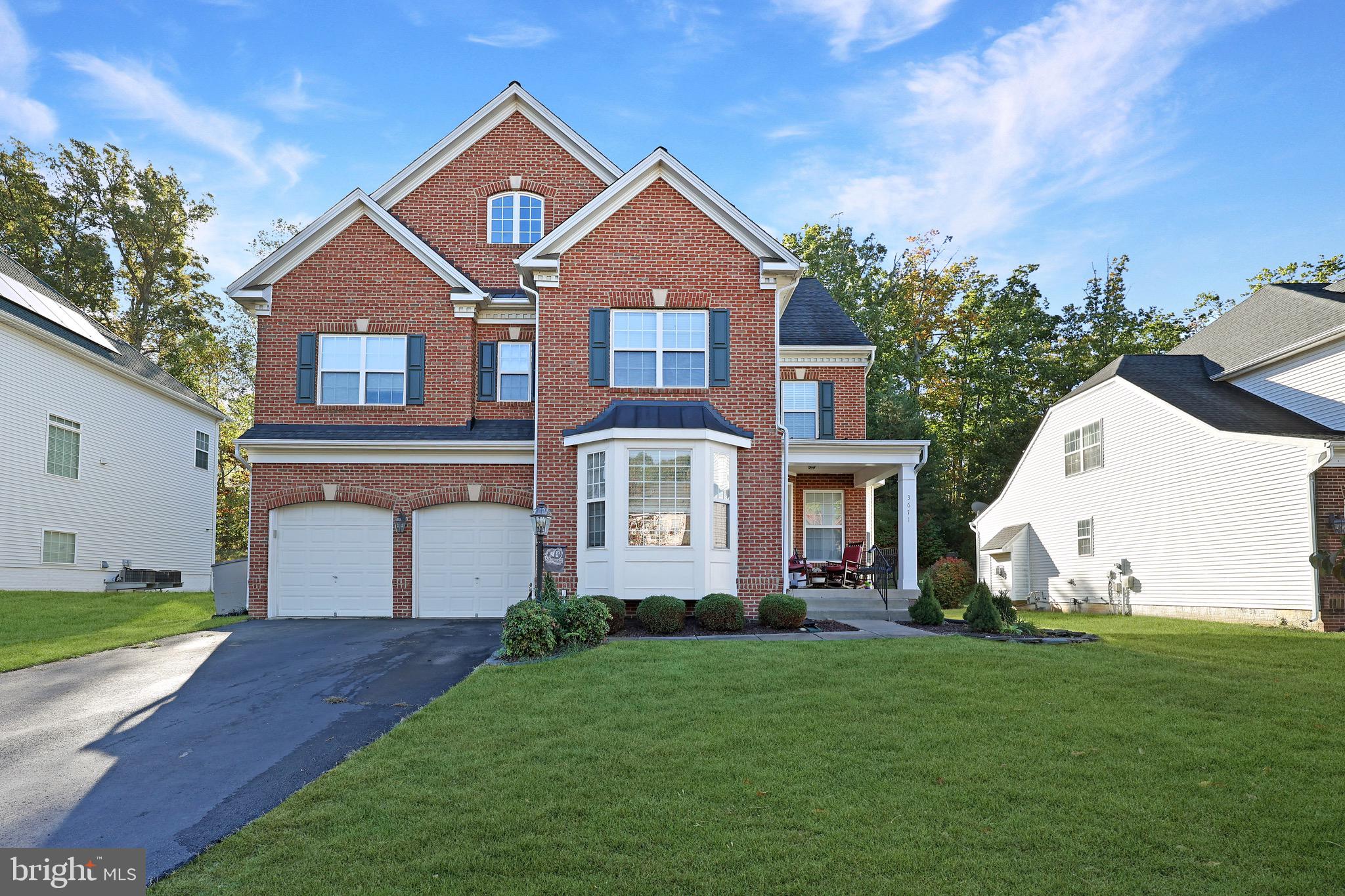 3671 Expedition Drive Triangle, VA 22172 - Photo 3 of 55 a front view of a house with garden