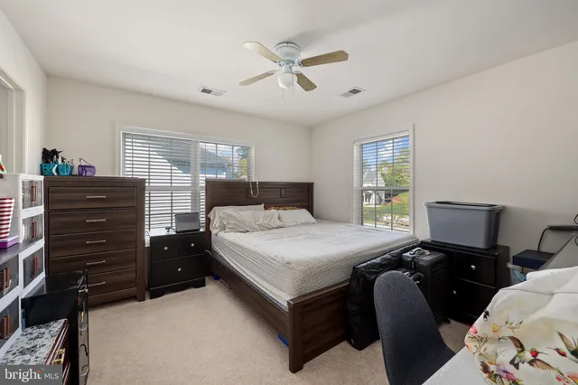 a bedroom with bed chair and window