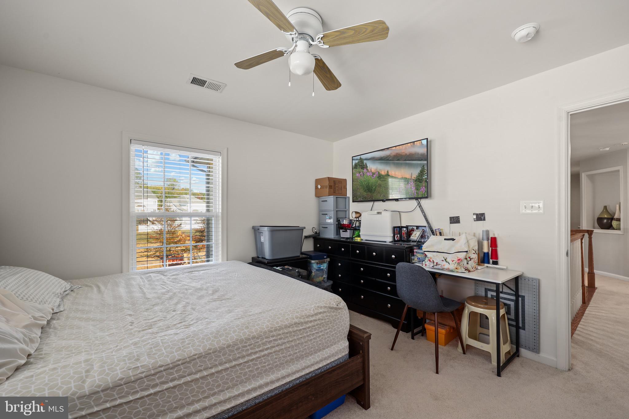 3671 Expedition Drive Triangle, VA 22172 - Photo 38 of 55 a bedroom with a bed and a table