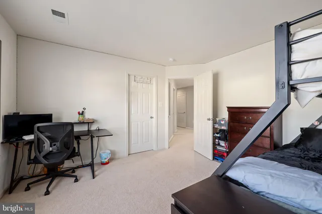 a bedroom with bed and wooden floor