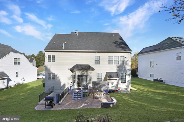 a view of a house with backyard porch and sitting area