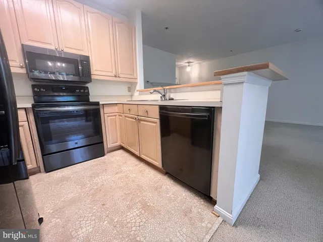 a kitchen with a refrigerator and a stove