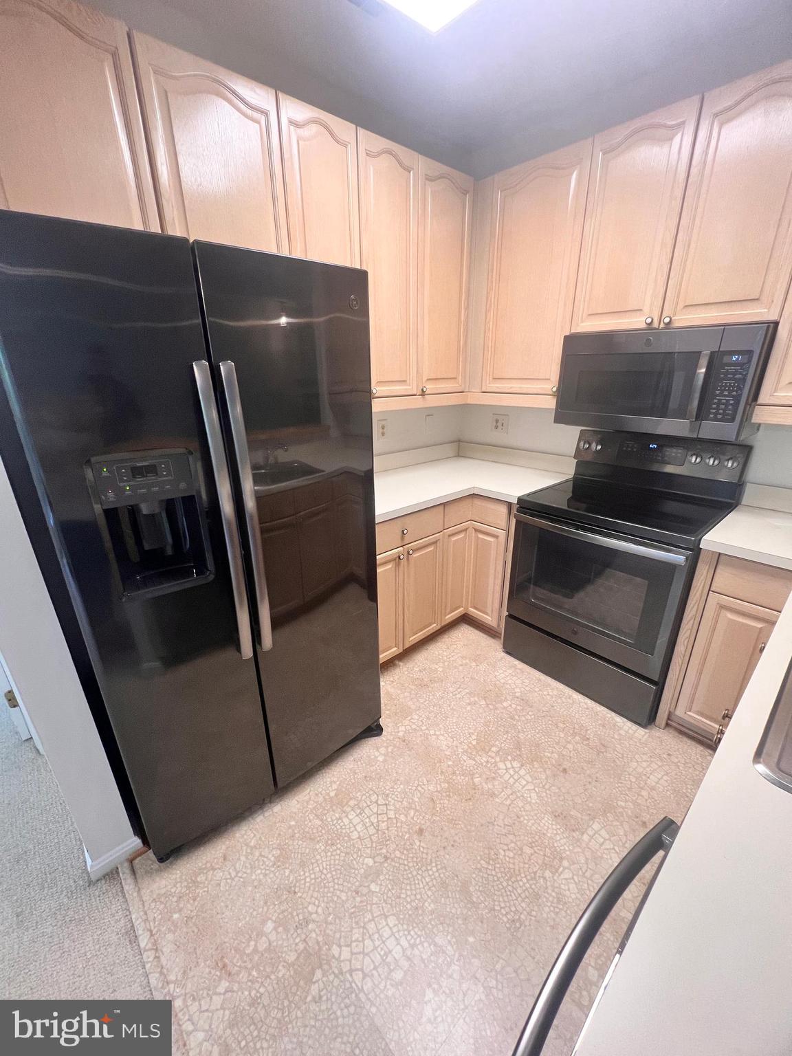 103 Square Rigger Way, Unit 103 Solomons, MD 20688 - Photo 13 of 21 a kitchen with a refrigerator and a stove
