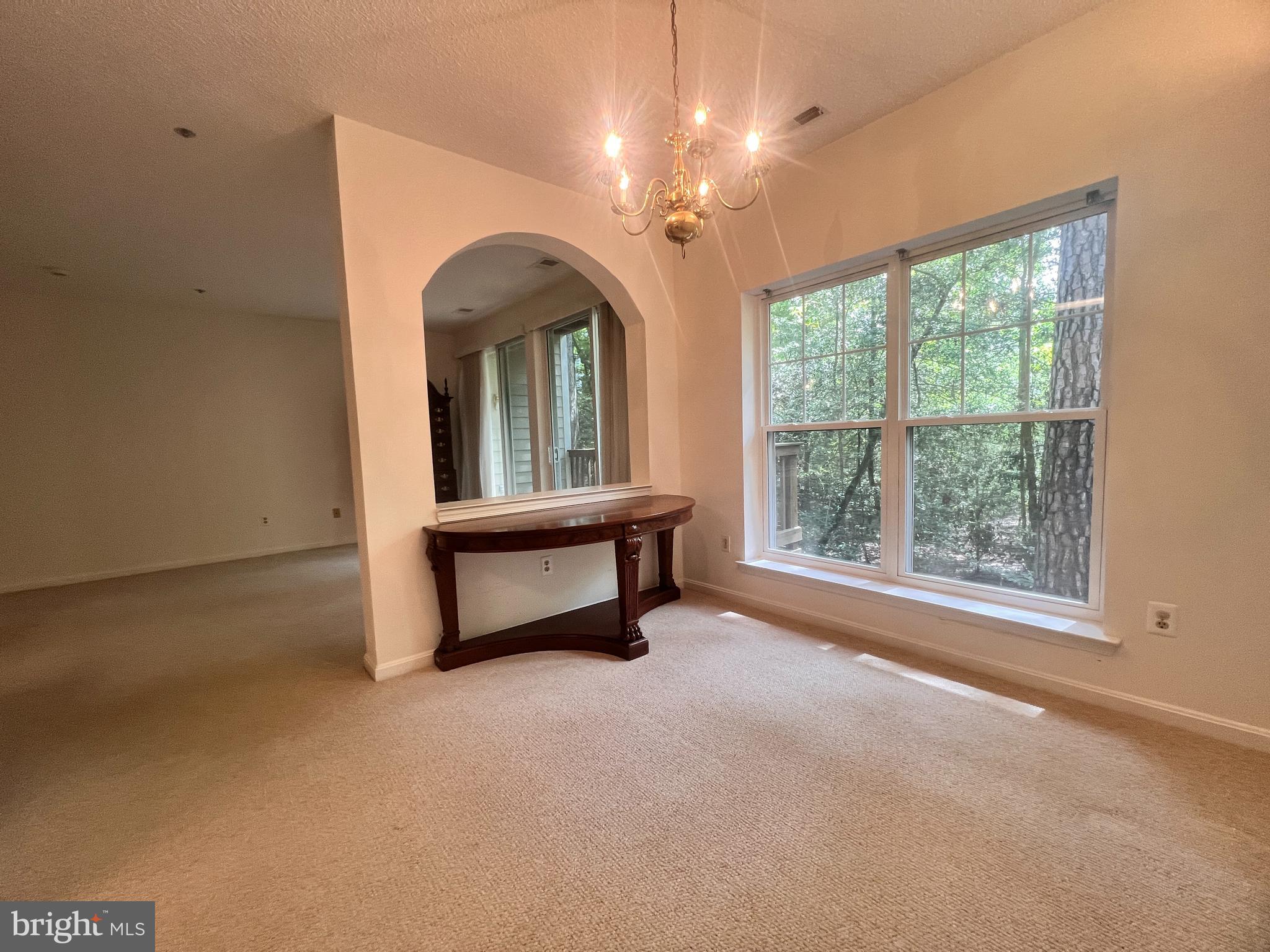 103 Square Rigger Way, Unit 103 Solomons, MD 20688 - Photo 14 of 21 a room with chandelier fan and windows