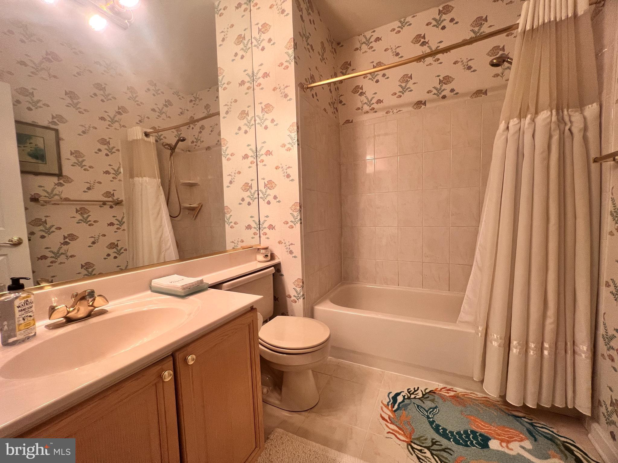 103 Square Rigger Way, Unit 103 Solomons, MD 20688 - Photo 15 of 21 a bathroom with a sink toilet and shower