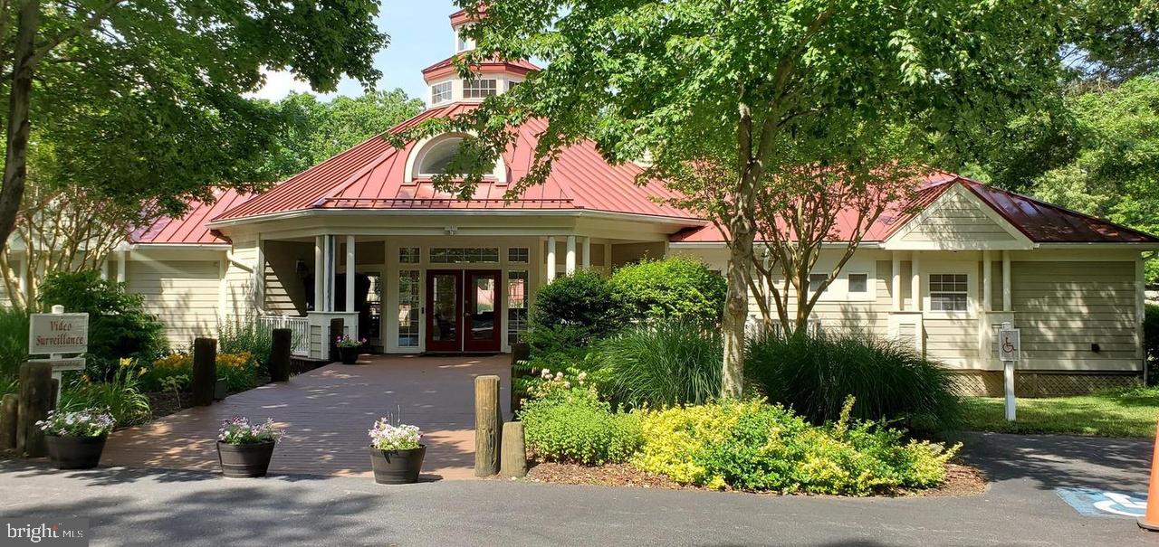 103 Square Rigger Way, Unit 103 Solomons, MD 20688 - Photo 10 of 21 a front view of a house with a garden