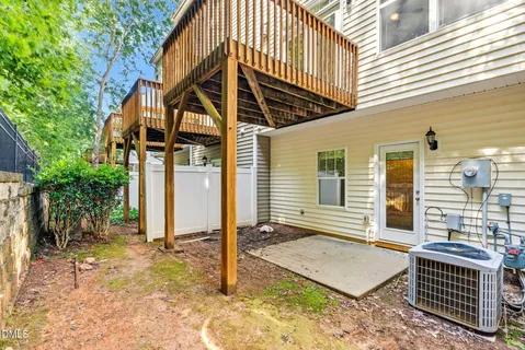 a kitchen with stainless steel appliances granite countertop a stove a sink a refrigerator white cabinets and a microwave oven