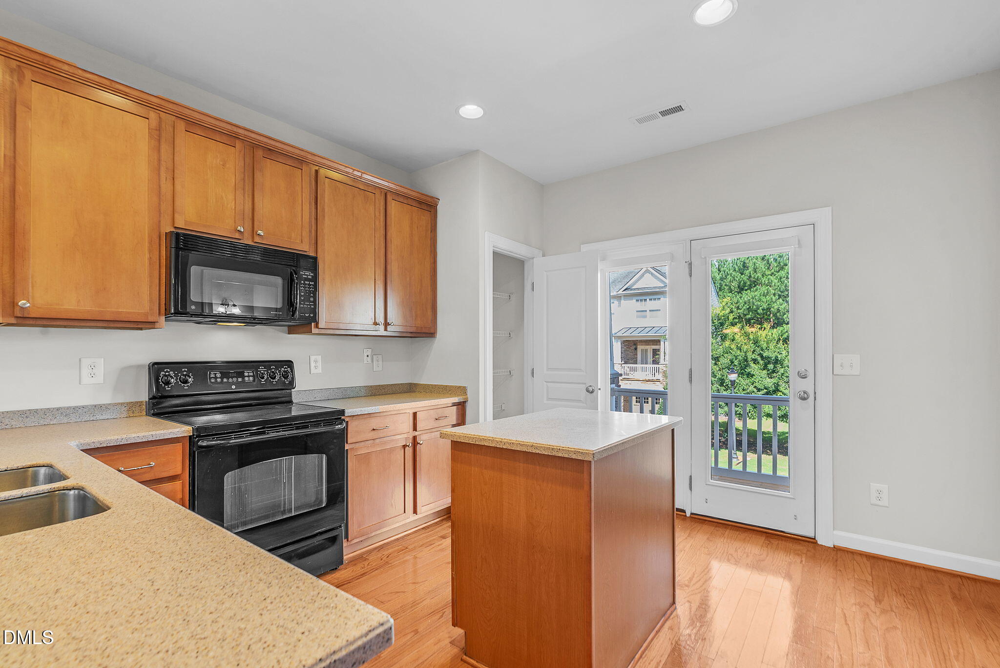 8032 Sycamore Hill Lane Raleigh, NC 27612 - Photo 19 of 59 a kitchen with stainless steel appliances granite countertop a stove a sink a refrigerator white cabinets and a microwave oven