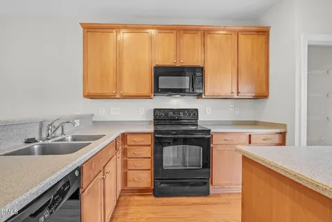 a kitchen with stainless steel appliances granite countertop a sink stove and cabinets