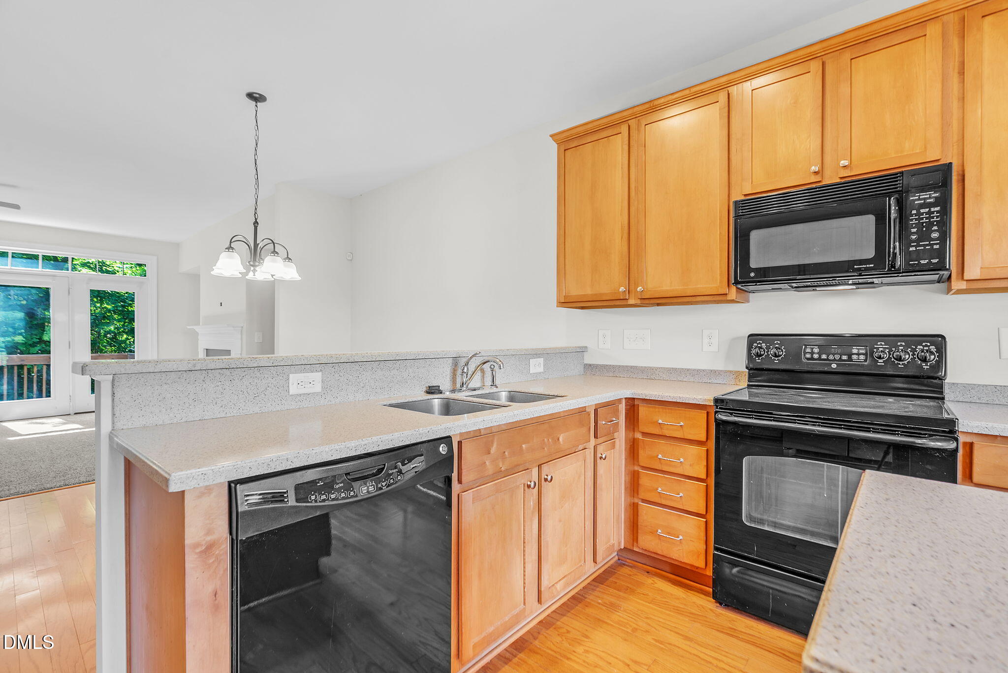 8032 Sycamore Hill Lane Raleigh, NC 27612 - Photo 21 of 59 a kitchen with stainless steel appliances granite countertop a sink stove and microwave