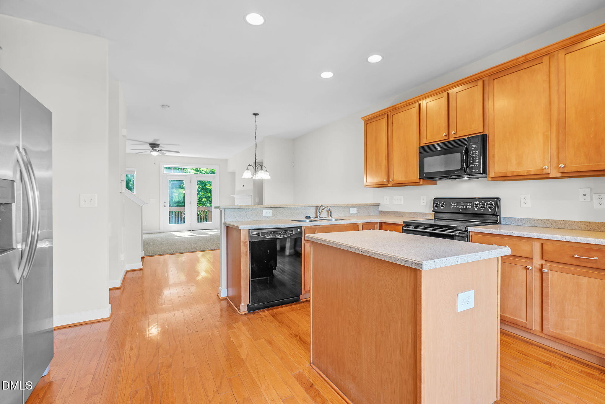 8032 Sycamore Hill Lane Raleigh, NC 27612 - Photo 22 of 59 a kitchen with a refrigerator a stove top oven a sink and cabinets