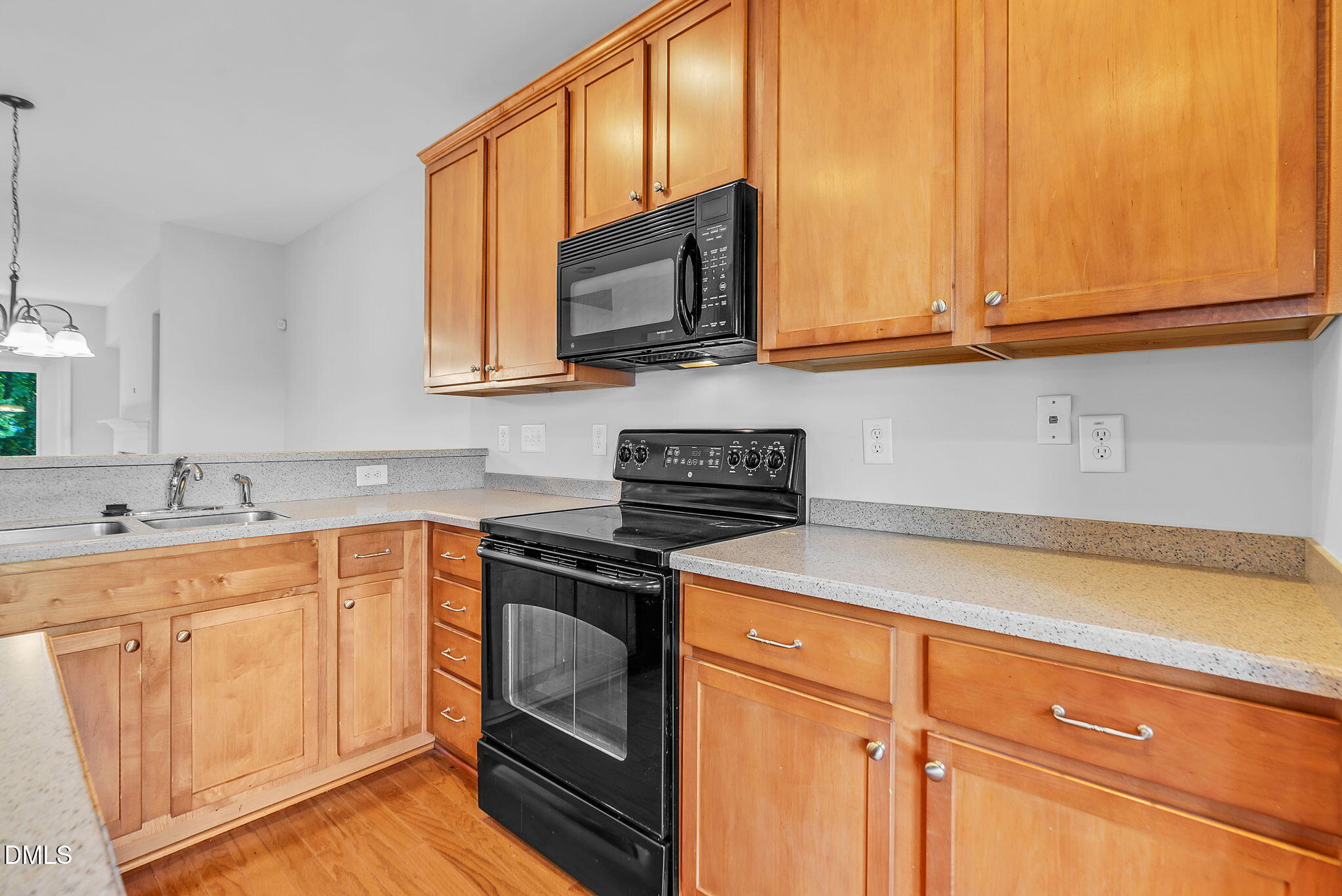 8032 Sycamore Hill Lane Raleigh, NC 27612 - Photo 23 of 59 a kitchen with stainless steel appliances granite countertop a sink stove and cabinets