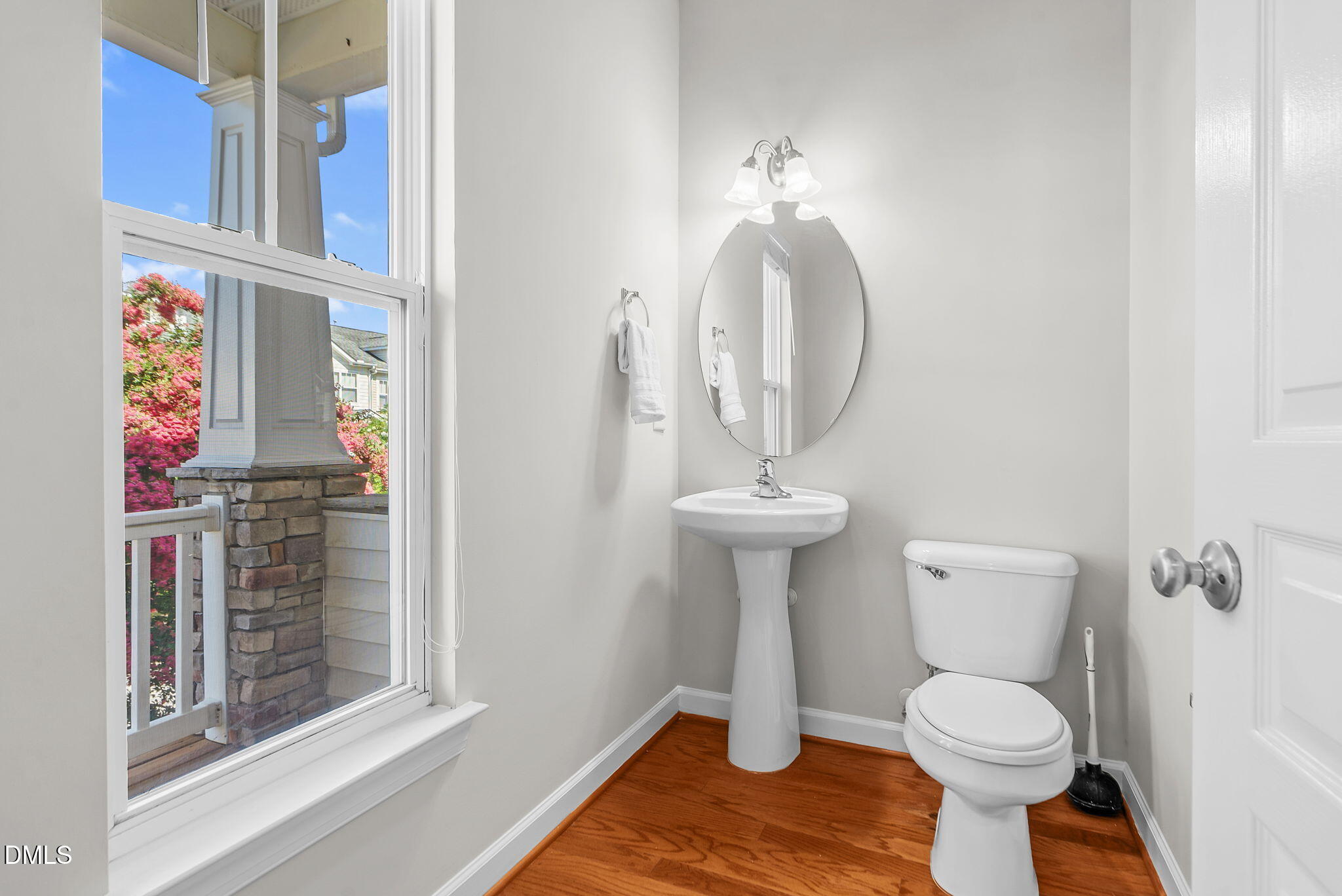 8032 Sycamore Hill Lane Raleigh, NC 27612 - Photo 28 of 59 a bathroom with a toilet sink and mirror