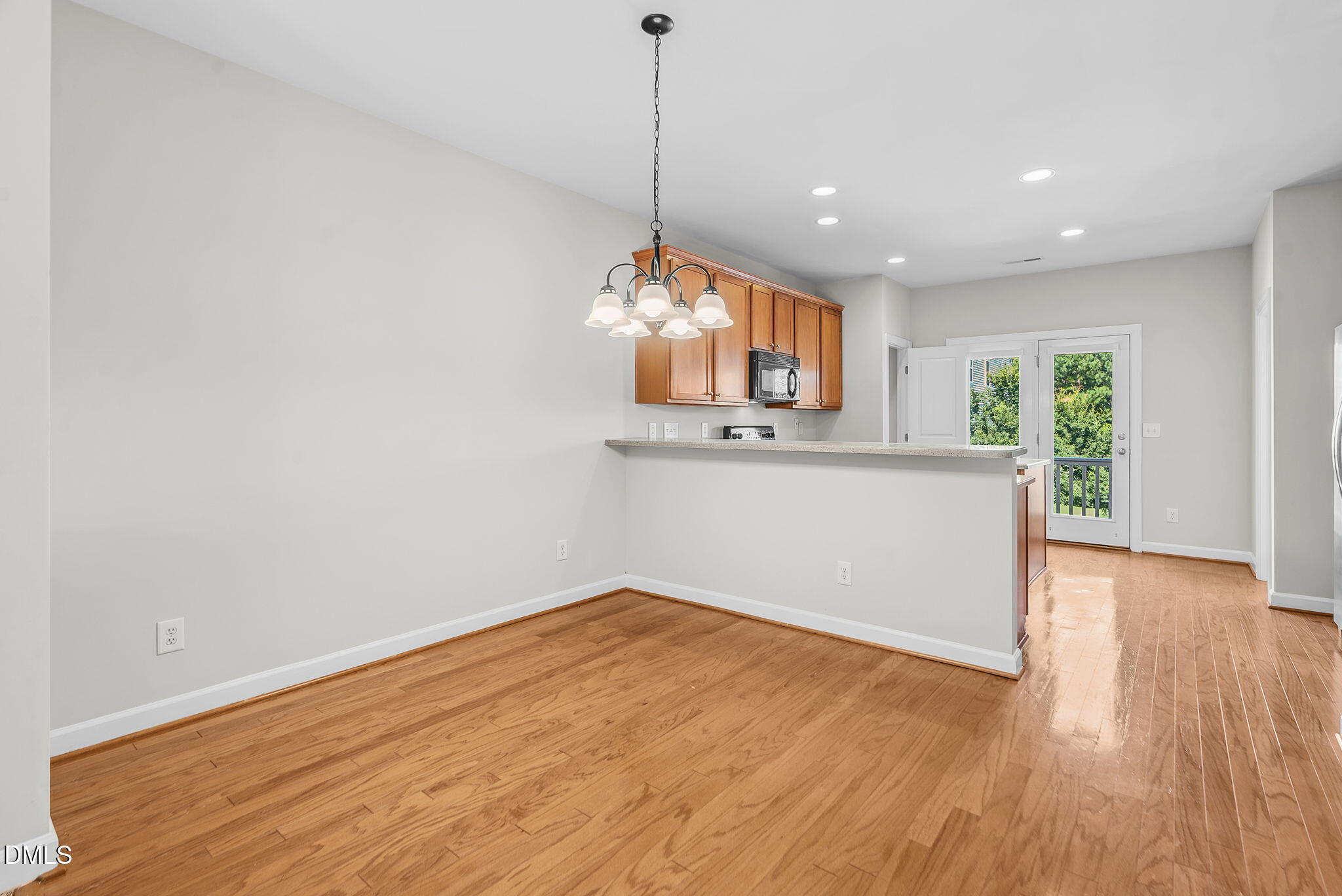 8032 Sycamore Hill Lane Raleigh, NC 27612 - Photo 34 of 59 a view of a kitchen with wooden floor and a window