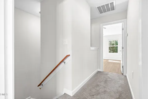 a view of empty room with window and ceiling fan