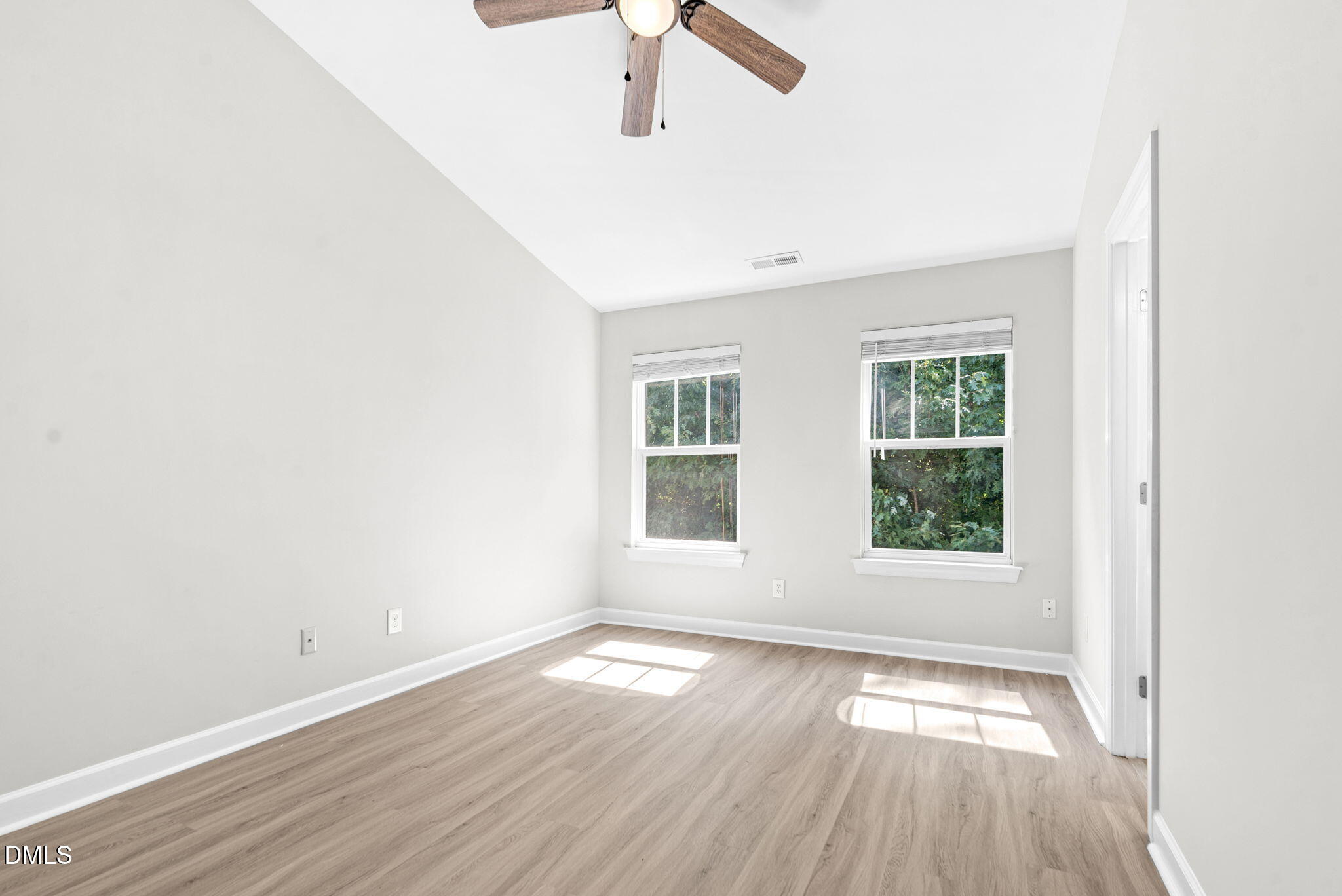 8032 Sycamore Hill Lane Raleigh, NC 27612 - Photo 44 of 59 an empty room with wooden floor fan and windows