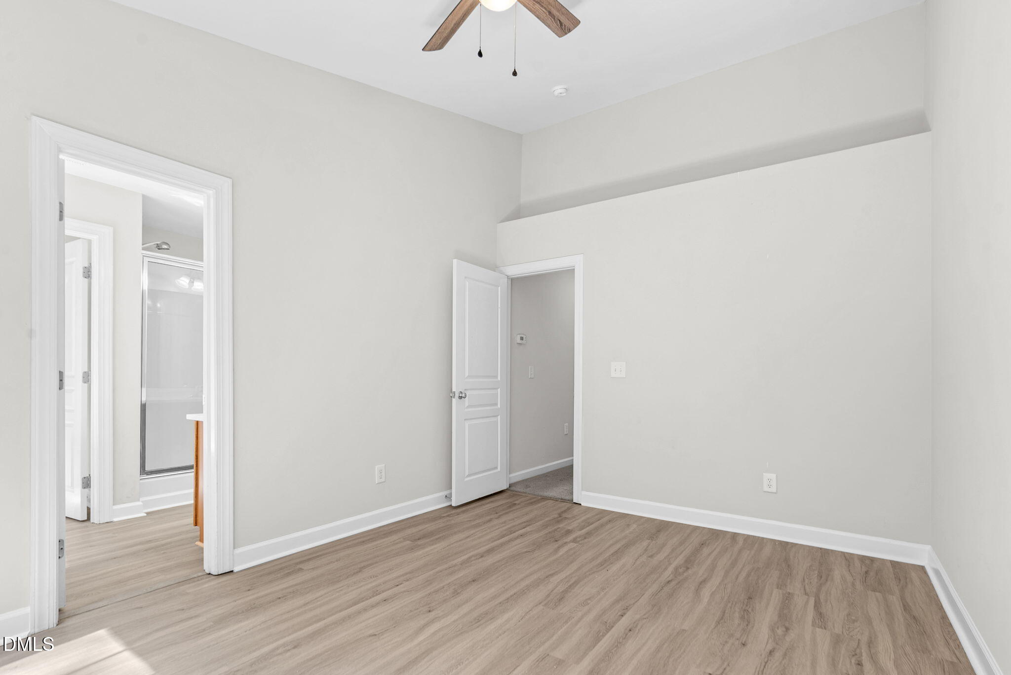 8032 Sycamore Hill Lane Raleigh, NC 27612 - Photo 45 of 59 an empty room with wooden floor and windows
