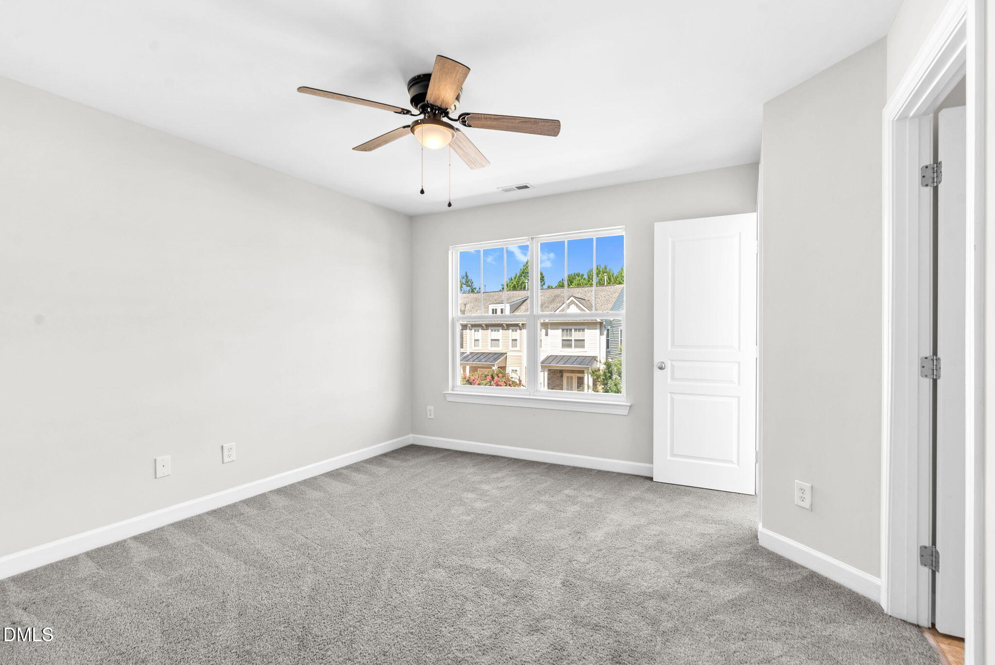 8032 Sycamore Hill Lane Raleigh, NC 27612 - Photo 52 of 59 a view of a livingroom with a ceiling fan & windows
