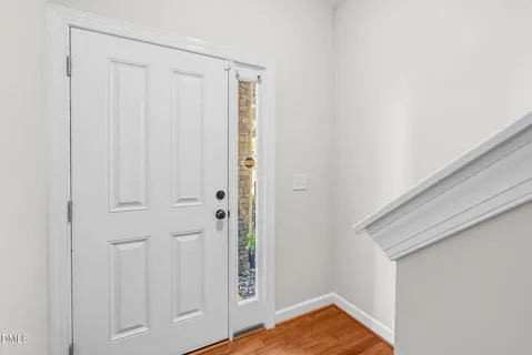 a view of a room with wooden floor and cabinet