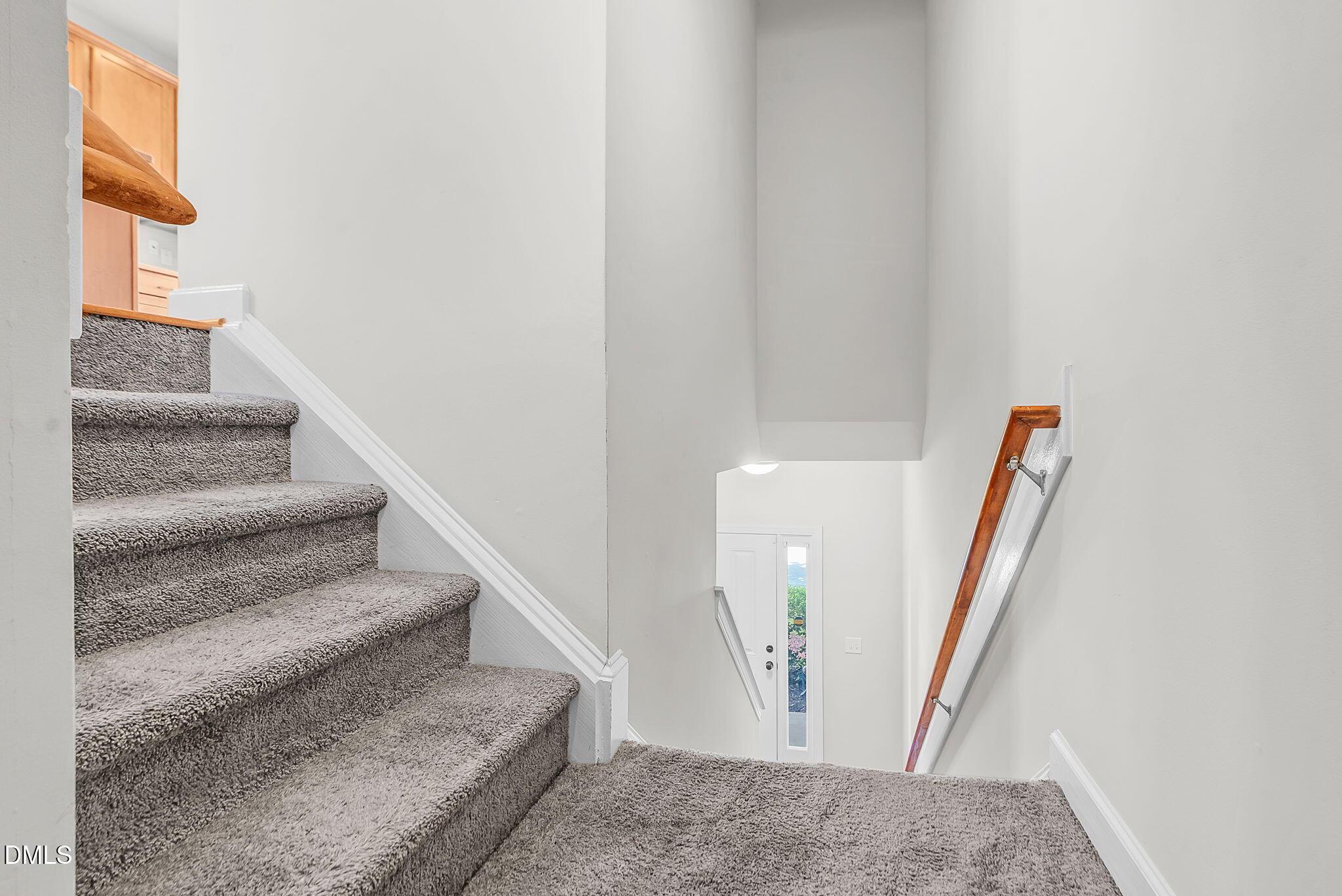8032 Sycamore Hill Lane Raleigh, NC 27612 - Photo 9 of 59 a view of staircase with white walls and railing