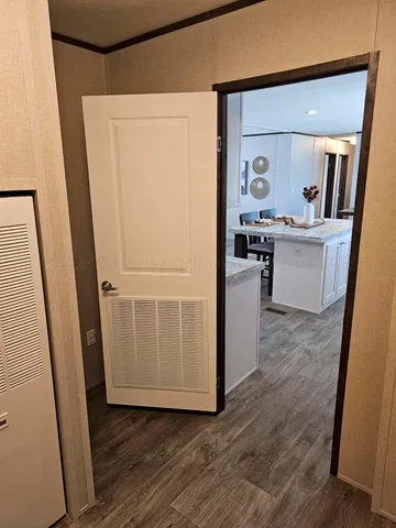 a hallway with cabinets and wooden floor
