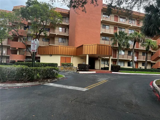 a view of staircase with a large window and wooden floor
