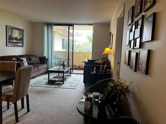 a living room with furniture fireplace and a large window