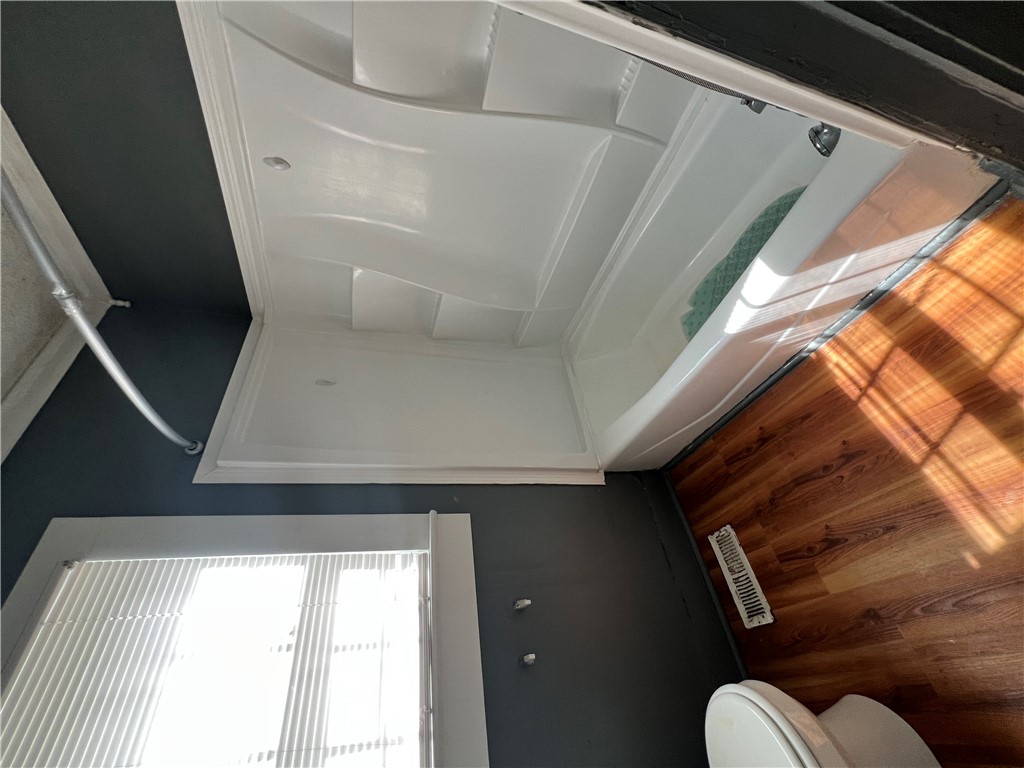 309 Jaynes Street Walhalla, SC 29691 - Photo 11 of 12 Brightly illuminated with natural light, this bathroom features a combined shower and bathtub.